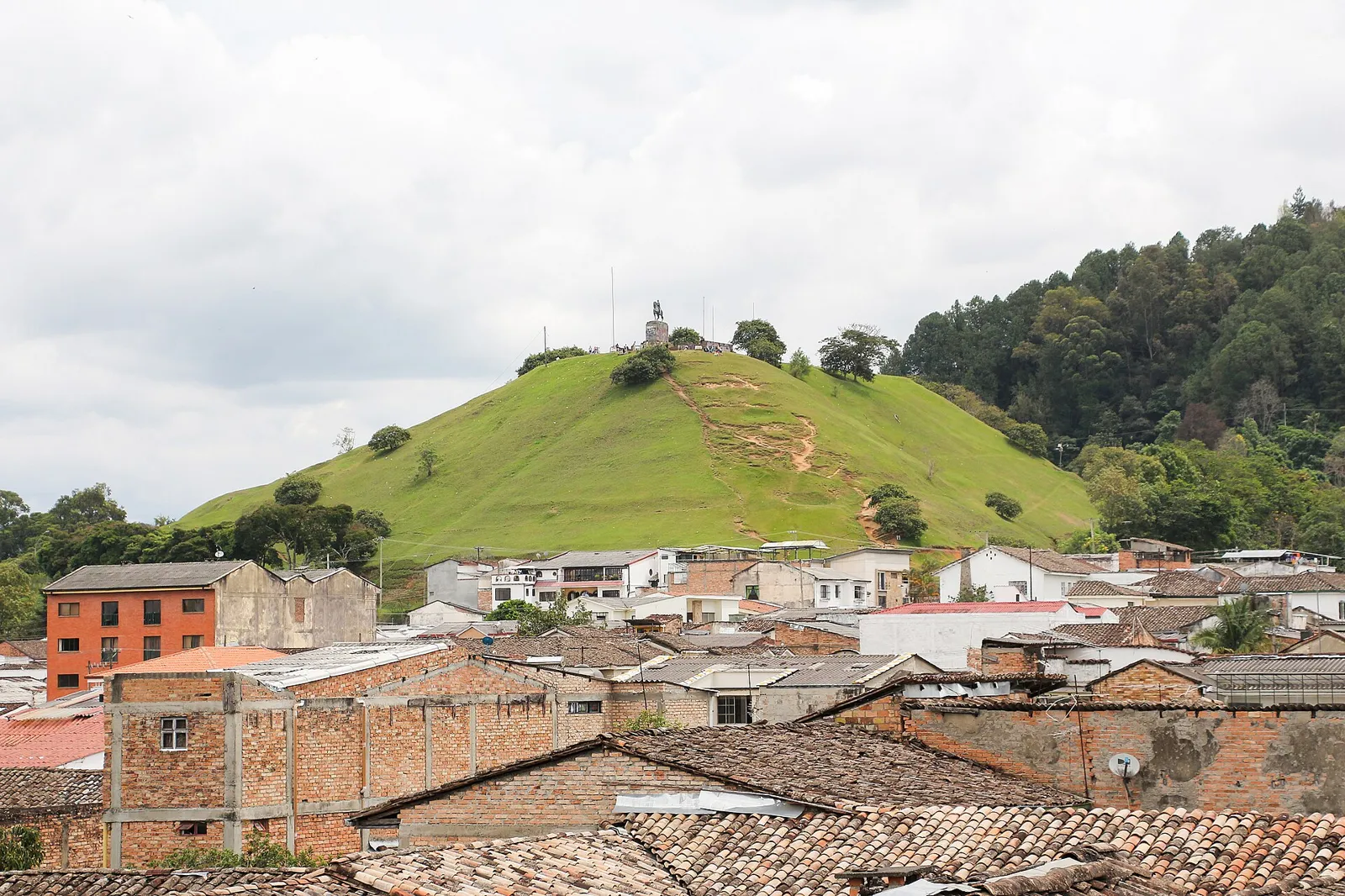 Morro de Tulcán, colina gramada com a estátua de Belalcázar no topo, vista sobre os telhados de Popayán